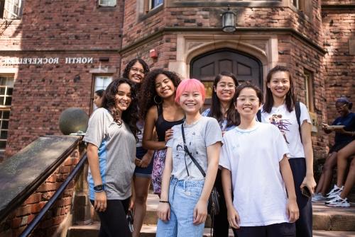 A group of first year students on the steps of North Rockefeller Hall during orientation
